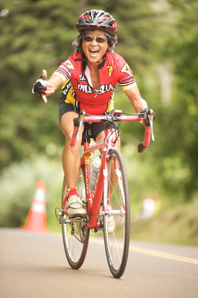 Rider flashing a shaka at the finish line