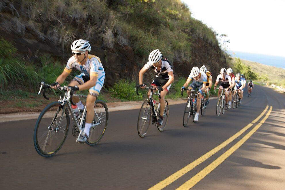 Racers shaded by canyon walls